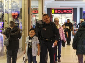 Const. Ryan Wolinski shops with Benjamin, 8, as part of the 2018 Cop Shop event at St. Vital Centre. Luke Rempel/Postmedia