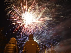 Spectators watch the fireworks during New Year's Eve celebration.