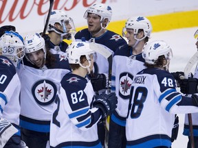 The Winnipeg Jets celebrate their win over the Vancouver Canucks during following third period NHL action at Rogers Arena in Vancouver, Saturday.