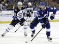 Tampa Bay Lightning center Steven Stamkos (91) carries the puck past Winnipeg Jets center Mark Scheifele (55) during the second period of an NHL hockey game Saturday, Dec. 9, 2017, in Tampa, Fla.