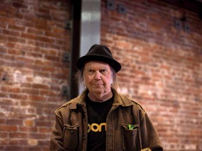Canadian musician Neil Young leaves a news conference in Vancouver on Monday, Nov. 23, 2015.
