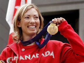 Canadian cross-country skier Beckie Scott displays her gold medal she was awarded at a ceremony in Vancouver, Friday, June 25, 2004. Scott is among the 103 newest appointments to the Order of Canada, the cornerstone of the Canadian honours system whose ranks are now closing in on 7,000 members. TTHE CANADIAN PRESS/Chris Bolin ORG XMIT: CPT107