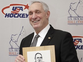 Retired NHL referee Paul Stewart poses with his plaque before being inducted into the U.S. Hockey Hall of Fame, Wednesday, Dec. 12, 2018, in Nashville, Tenn. (AP Photo/Mark Humphrey)