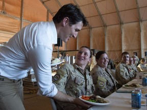 Canadian Prime Minister Justin Trudeau serves turkey dinner to members of the Canadian Armed Forces serving on the United Nations Multidimensional Integrated Stabilization Mission in Gao, Mali, Saturday, December 22, 2018.