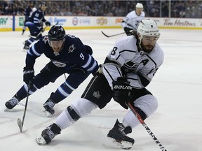 Los Angeles Kings defenceman Drew Doughty (right) spins away from Winnipeg Jets centre Andrew Copp in Winnipeg on Tues., March 20, 2018. Kevin King/Winnipeg Sun/Postmedia Network