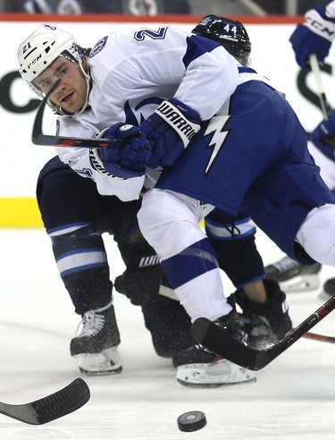 Tampa Bay Lightning centre Brayden Point makes a pass as he is checked by Winnipeg Jets defenceman Josh Morrissey in Winnipeg on Sun., Dec. 16, 2018. Kevin King/Winnipeg Sun/Postmedia Network