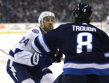 Tampa Bay Lightning forward Ryan Callahan (left) prepares for a hit on Winnipeg Jets defenceman Jacob Trouba in Winnipeg on Sun., Dec. 16, 2018. Kevin King/Winnipeg Sun/Postmedia Network