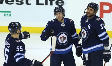 Winnipeg Jets forward Nikolaj Ehlers (centre) celebrates his second-period goal against the Tampa Bay Lightning in Winnipeg with Mark Scheifele (left) and Dustin Byfuglien on Sun., Dec. 16, 2018. Kevin King/Winnipeg Sun/Postmedia Network