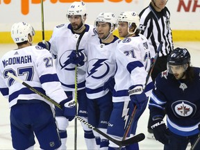 Tampa Bay Lightning centre Tyler Johnson (centre) celebrates his second-period goal against the Winnipeg Jets  in Winnipeg with Ryan McDonagh, Nikita Kucherov and Brayden Point (from left) on Sun., Dec. 16, 2018. Kevin King/Winnipeg Sun/Postmedia Network