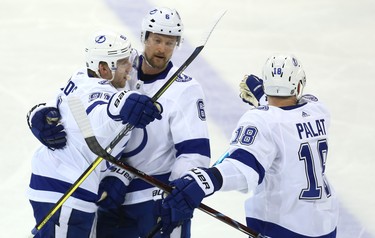 Tampa Bay Lightning forward Steven Stamkos (left) celebrates his second-period goal against the Winnipeg Jets  in Winnipeg with Anton Stralman (centre) and Ondrej Palat on Sun., Dec. 16, 2018. Kevin King/Winnipeg Sun/Postmedia Network