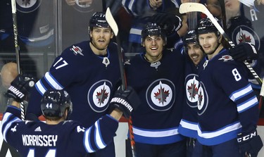 Winnipeg Jets forward Brandon Tanev (centre) celebrates his second-period goal against the Tampa Bay Lightning in Winnipeg with Josh Morrissey, Adam Lowry, Mathieu Perreault and Jacob Trouba (from left) on Sun., Dec. 16, 2018. Kevin King/Winnipeg Sun/Postmedia Network