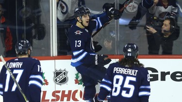 Winnipeg Jets forward Brandon Tanev (centre) celebrates his second-period goal against the Tampa Bay Lightning in Winnipeg with Adam Lowry (left) and Mathieu Perreault on Sun., Dec. 16, 2018. Kevin King/Winnipeg Sun/Postmedia Network