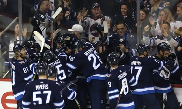 The Winnipeg Jets celebrate their overtime win over the Tampa Bay Lightning in Winnipeg on Sun., Dec. 16, 2018. Kevin King/Winnipeg Sun/Postmedia Network