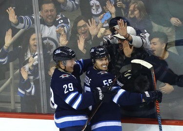 Winnipeg Jets centre Mark Scheifele (right) celebrates his overtime goal against the Tampa Bay Lightning in Winnipeg with Patrik Laine on Sun., Dec. 16, 2018. Kevin King/Winnipeg Sun/Postmedia Network