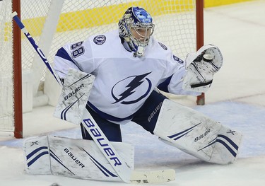 Tampa Bay Lightning goaltender Andrei Vasilevskiy makes a glove save off Winnipeg Jets defenceman Jacob Trouba in Winnipeg on Sun., Dec. 16, 2018. Kevin King/Winnipeg Sun/Postmedia Network