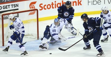 Tampa Bay Lightning goaltender Andrei Vasilevskiy makes a kick save with Winnipeg Jets forward Patrik Laine open in front in Winnipeg on Sun., Dec. 16, 2018. Kevin King/Winnipeg Sun/Postmedia Network