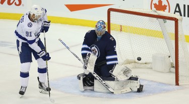 A shot goes wide of Winnipeg Jets goaltender Connor Hellebuyck as Tampa Bay Lightning forward Steven Stamkos attempt to tip it in Winnipeg on Sun., Dec. 16, 2018. Kevin King/Winnipeg Sun/Postmedia Network