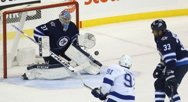 Winnipeg Jets goaltender Connor Hellebuyck stares down a shot from Tampa Bay Lightning forward Steven Stamkos in Winnipeg on Sun., Dec. 16, 2018. Kevin King/Winnipeg Sun/Postmedia Network