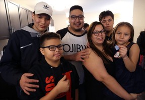 The Beaulieu family Ñ from left, Jordan, 15, Eric, 12, Craig, Leann, Quinton, 14, and Tierra, 7 Ñ are pictured in their new Habitat for Humanity home on Flora Avenue in Winnipeg on Wed., Dec. 19, 2018. The family will move in on Friday. Kevin King/Winnipeg Sun/Postmedia Network