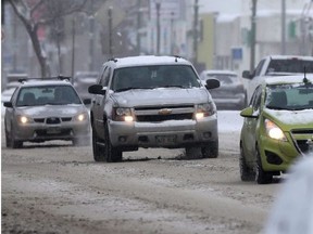 Drivers navigate Winnipeg roads during a snowfall on Saturday.