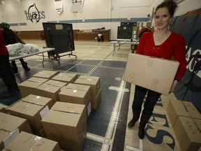 Leanne Edwards moves boxes while participating in the annual hamper drive for Ma Mawi Chi Itata Centre and Bell MTS on Saturday.