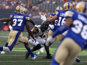 Hamilton Tiger-Cats WR Brandon Banks is surrounded by Winnipeg Blue Bombers defenders during CFL action in Winnipeg on Fri., Aug. 10, 2018. Kevin King/Winnipeg Sun/Postmedia Network