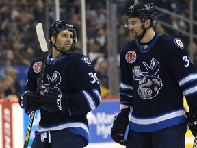 Seth Griffith (left) and Logan Shaw of the Manitoba Moose speak during a break before taking to the power play against the Colorado Eagles in Winnipeg on Sun., Dec. 30, 2018. Kevin King/Winnipeg Sun/Postmedia Network