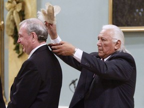 Elder Elmer Courchene performs a cleansing ceremony on Liberal Leader Paul Martin prior to being sworn in as Canada's 21th Prime Minister during a ceremony Friday, Dec 12, 2003 in Ottawa. Courchene died from lung cancer on Dec. 5 at the age of 82. He was known as Standing Strong Man, had been with the Assembly of First Nations since 2005 and advised National Chief Perry Bellegarde and former national chiefs Phil Fontaine and Shawn Atleo.THE CANADIAN PRESS/Tom Hanson