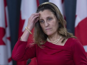 Minister of Foreign Affairs Chrystia Freeland runs her hand through her hair as she speaks with the media during a news conference in Ottawa, Wednesday Dec. 12, 2018. THE CANADIAN PRESS/Adrian Wyld