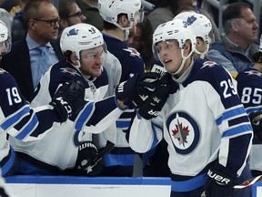 Winnipeg Jets' Patrik Laine (29), is congratulated by Brendan Lemieux after scoring one of his five goals against the St. Louis Blues, Saturday, Nov. 24, in St. Louis.