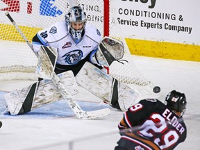 Kootenay Ice goaltender Duncan McGovern makes a save on the Calgary Hitmen's Kaden Elder during WHL hockey action at the Scotiabank Saddledome in Calgary on Sunday, Nov. 11, 2018. The Ice are poised to move to Winnipeg.