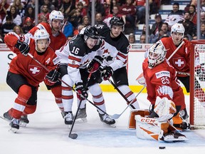 Canada's MacKenzie Entwistle is stopped by Switzerland goalie Akira Schmid during second period IIHF world junior hockey championship action in Vancouver, on Thursday Dec. 27, 2018.