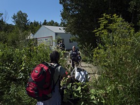 At the end of Roxham Rd. in Champlain, Fiyori Mesfin, 32, crosses into Canada with her three-year-old son and one-year-old daughter, both U.S. citizens.