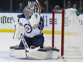 Winnipeg Jets goaltender Connor Hellebuyck (37) makes a save against the New York Rangers during the second period of an NHL hockey game, Sunday, Dec. 2, 2018, in New York.