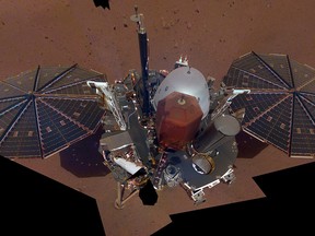 This composite image made available by NASA on Tuesday, Dec. 11, 2018 shows the InSight lander on the surface of Mars. The InSight lander used the camera on its long robotic arm to snap a series of pictures assembled into a selfie.