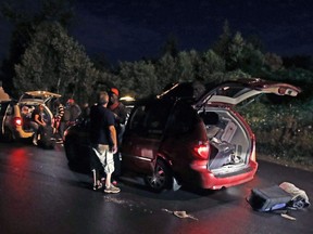 Taxis unload passengers, who travelled from a bus station in Plattsburgh, N.Y., at an unofficial border station across from Saint-Bernard-de-Lacolle, Quebec on Roxham Road in Champlain, N.Y., Aug. 8, 2017.