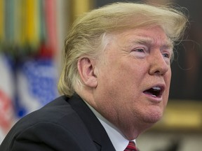 U.S. President Donald Trump answers questions from members of the media in the Oval Office at the White House Dec. 25, 2018 in Washington, D.C.