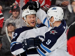 NEWARK, NEW JERSEY - DECEMBER 01:   Mason Appleton #82 of the Winnipeg Jets celebrates his assist with teammate and goal scoreer Andrew Copp #9 in the third period against the New Jersey Devils at Prudential Center on December 01, 2018 in Newark, New Jersey. Tonight was Appleton's first NHL game.