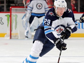 NEWARK, NEW JERSEY - DECEMBER 01:   Patrik Laine #29 of the Winnipeg Jets takes the puck in the third period against the New Jersey Devils at Prudential Center on December 01, 2018 in Newark, New Jersey.