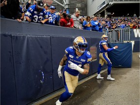 Winnipeg Blue Bombers FB Mike Miller (left) and QB Chris Streveler celebrate Streveler's touchdown plunge against the Saskatchewan Roughriders during CFL action in Winnipeg on Saturday, Sept. 8, 2018.The Blue Bombers have re-signed Canadian fullback and special-teams ace Mike Miller to a two-year contract.
