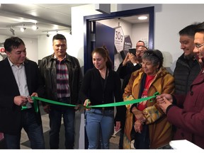 Manager Heather Pelletier (centre) cuts the ribbon to officially open the first legal recreational cannabis store on a Winnipeg urban reserve on Friday. Helping with the ribbon cutting is Long Plain First Nation Chief Dennis Meeches (far left), Tim Daniels, CEO of Arrowhead Development Corporation (second from left) and Onekanew (Chief) Christian Sinclair of Opaskwayak Cree Nation and National Access Cannabis Board Member (far right, holding ribbon) along with other band council members.