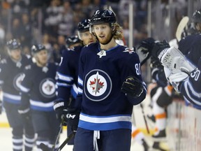 Winnipeg Jets forward Kyle Connor celebrates his goal against the Philadelphia Flyers in Winnipeg with teammates on the bench on Sun., Dec. 9, 2018. Kevin King/Winnipeg Sun/Postmedia Network