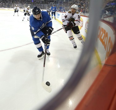 Winnipeg Jets centre Bryan Little (left) is pestered by Chicago Blackhawks forward Chris Kunitz in Winnipeg on Tues., Dec. 11, 2018. Kevin King/Winnipeg Sun/Postmedia Network