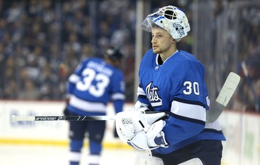 Winnipeg Jets goaltender Laurent Brossoit heads back to his net after a break in play against the Chicago Blackhawks in Winnipeg on Tues., Dec. 11, 2018. Kevin King/Winnipeg Sun/Postmedia Network