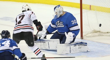 A shot from Chicago Blackhawks centre Dylan Strome gets past Winnipeg Jets goaltender Laurent Brossoit but goes wide of the net in Winnipeg on Tues., Dec. 11, 2018. Kevin King/Winnipeg Sun/Postmedia Network