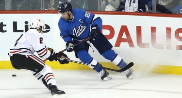 Winnipeg Jets forward Blake Wheeler (left) tries to get away from Chicago Blackhawks defenceman Duncan Keith in Winnipeg on Tues., Dec. 11, 2018. Kevin King/Winnipeg Sun/Postmedia Network