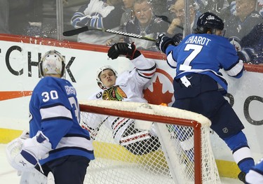 Winnipeg Jets defenceman Ben Chiarot (right) levels  Chicago Blackhawks centre David Kampf in Winnipeg on Tues., Dec. 11, 2018. Kevin King/Winnipeg Sun/Postmedia Network