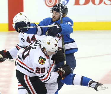 Winnipeg Jets forward Kyle Connor (right) runs into Chicago Blackhawks forward Brandon Saad in Winnipeg on Tues., Dec. 11, 2018. Kevin King/Winnipeg Sun/Postmedia Network