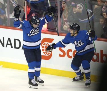 Winnipeg Jets forward Mathieu Perreault (left) celebrates his third-period, power-play goal against the Chicago Blackhawks with Nikolaj Ehlers in Winnipeg on Tues., Dec. 11, 2018. Kevin King/Winnipeg Sun/Postmedia Network