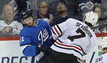 Winnipeg Jets forward Kyle Connor (left) is run over by Chicago Blackhawks defenceman Brent Seabrook in Winnipeg on Tues., Dec. 11, 2018. Kevin King/Winnipeg Sun/Postmedia Network